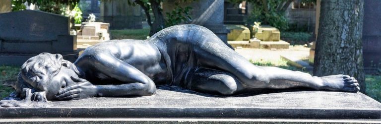 Statue of woman lying on her side crying into her hands How to thrive as an empath