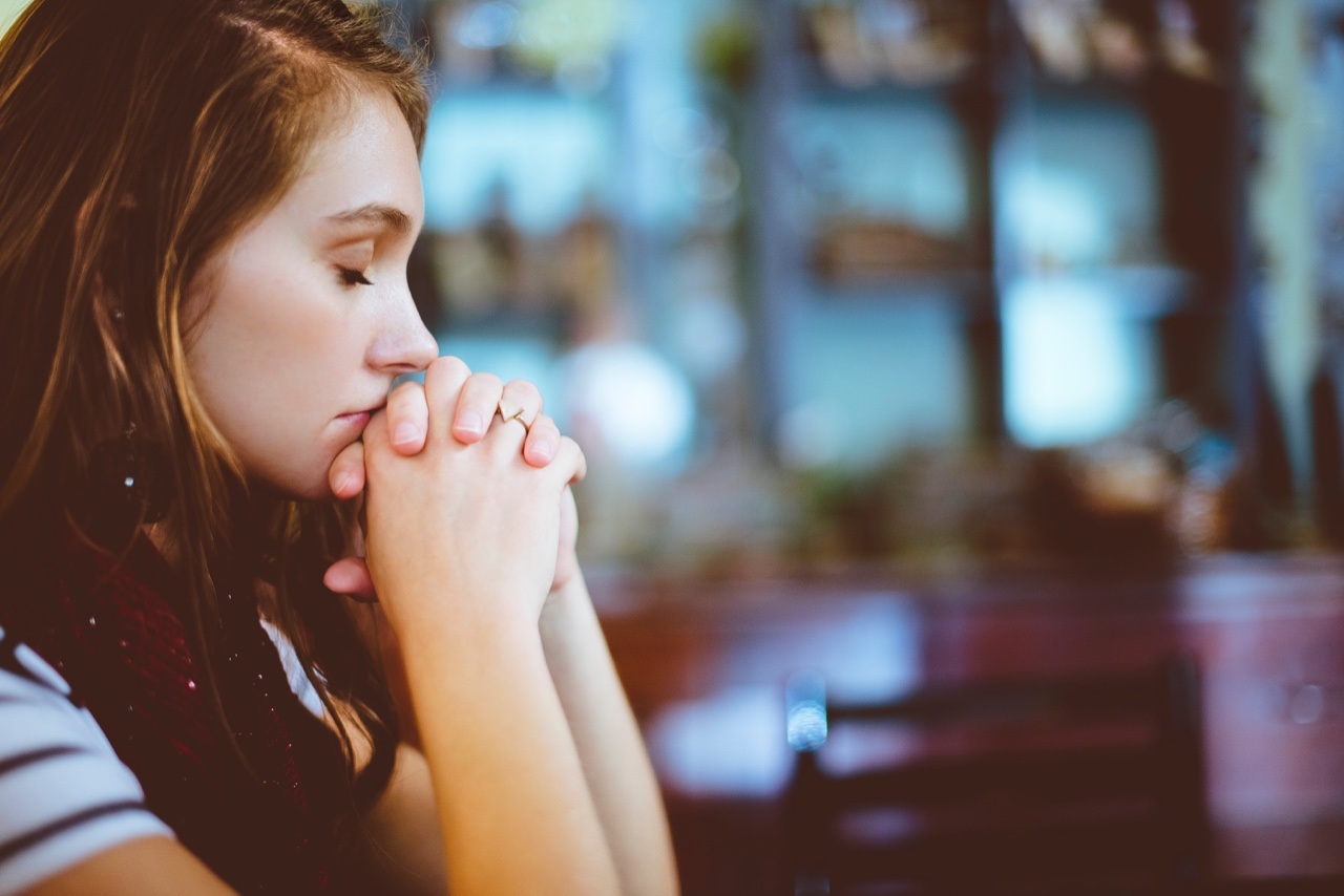 Woman praying with her eyes closed
Empath's Holiday