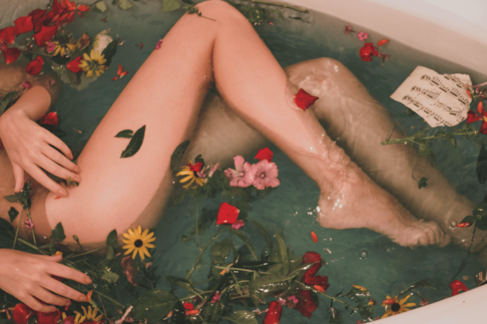 Woman in bath of flowers being an empath during a pandemic