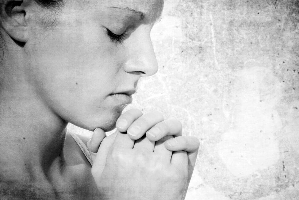 woman praying spiritual self-care