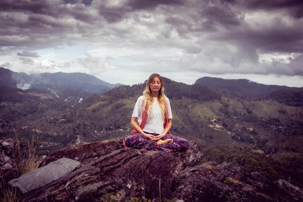 woman meditating on a mountain