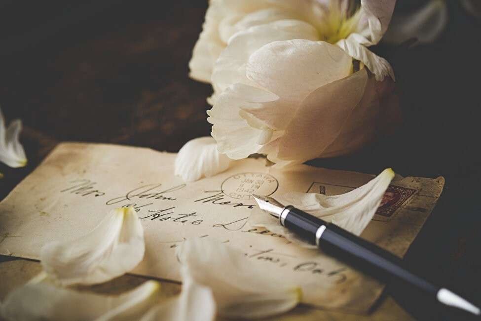 old letter with calligraphy pen and white flower how to forgive