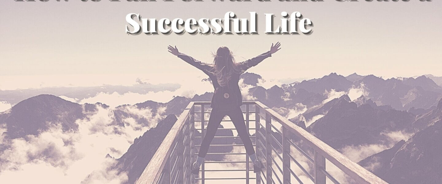 woman standing with arms outstretched looking out at the mountains fail forward